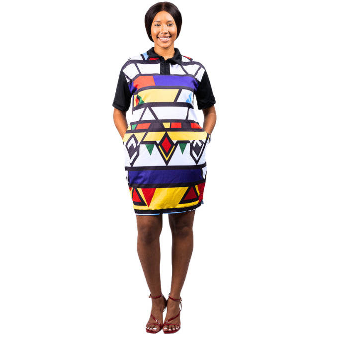 Woman wearing a colorful ndebele geometric patterned ndebele dress by tribe afrique on a white background