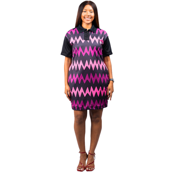Woman wearing a black and pink zigzag patterned ndebele golfer dress on a white background